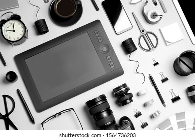 Flat lay composition with graphic drawing tablet and different office items on light background. Designer's workplace