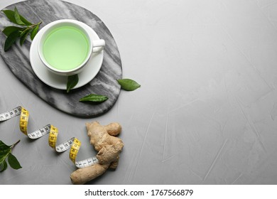 Flat lay composition with herbal diet tea and measuring tape on light table. Space for text