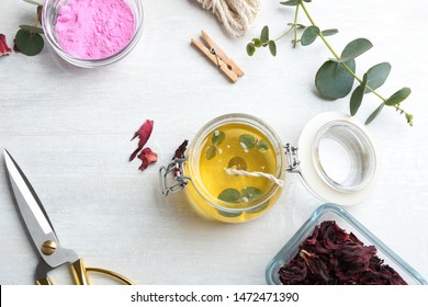 Flat Lay Composition With Homemade Candle In Glass Jar On Light Table