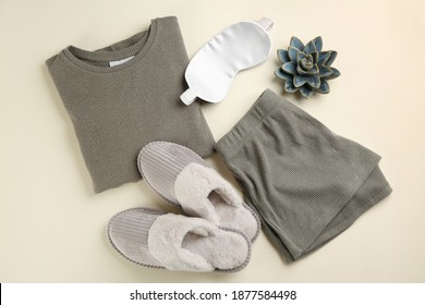 Flat Lay Composition With House Slippers, Sleeping Mask And Pajamas On Light Background