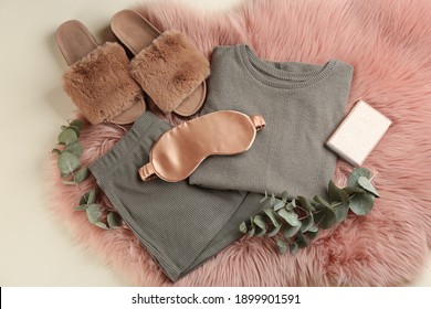 Flat Lay Composition With House Slippers, Sleeping Mask And Pajamas On Light Background