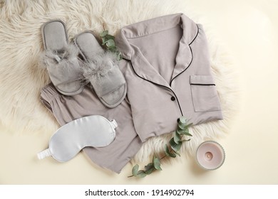 Flat Lay Composition With House Slippers, Sleeping Mask And Pajamas On Light Background