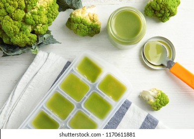 Flat Lay Composition With Ice Cube Tray Of Baby Food On Wooden Background