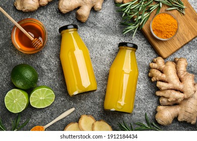 Flat lay composition with immunity boosting drink in bottles on grey table