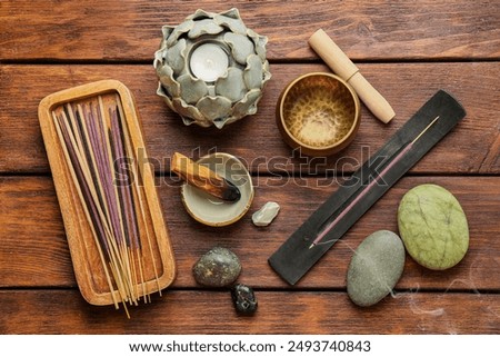 Flat lay composition with incense sticks on wooden table. Om ligature
