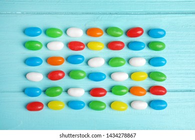 Flat lay composition with jelly beans on color background