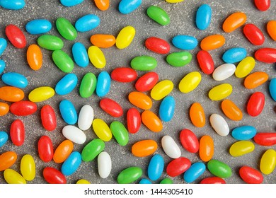 Flat lay composition with jelly beans on stone background