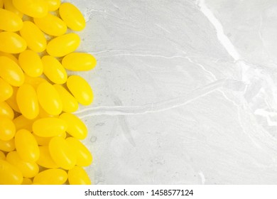 Flat lay composition with jelly beans on light background. Space for text