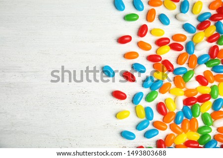 Flat lay composition with jelly beans on light background. Space for text