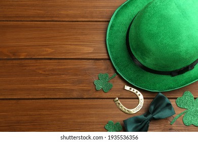 Flat lay composition with leprechaun hat on wooden table, space for text. St Patrick's Day celebration