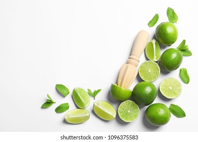 Flat lay composition with lime, mint and juicer on light background. Refreshing beverage ingredients