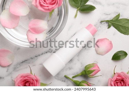 Flat lay composition with lip balm on white marble background