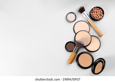 Flat lay composition with makeup brushes on light background, space for text