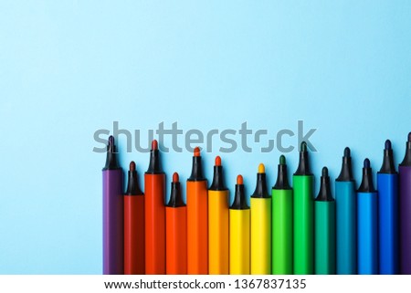 Flat lay composition with markers and space for text on color background. Rainbow palette