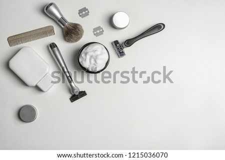 Flat lay composition with men's shaving accessories and space for text on white background