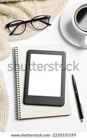 Flat lay composition with modern e-book reader on white table