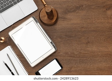 Flat lay composition with modern tablet on wooden table. Space for text