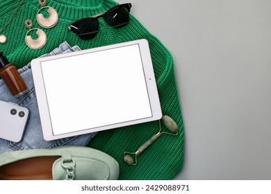 Flat lay composition with modern tablet on light grey background. Space for text