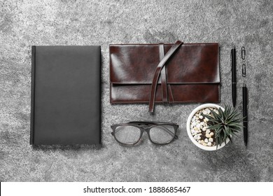 Flat lay composition with notebook and glasses on grey background