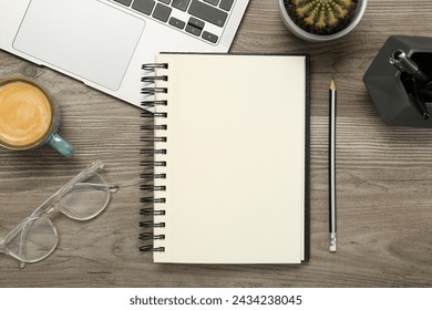 Flat lay composition with notebook and laptop on wooden table