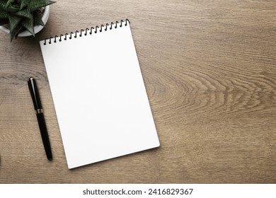 Flat lay composition with notebook on wooden table