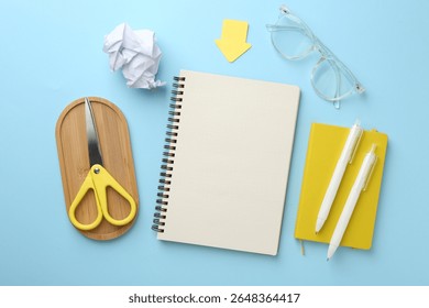 Flat lay composition with notebook on light blue background