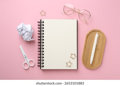 Flat lay composition with notebook on pink background