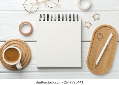 Flat lay composition with open blank notebook on white wooden table