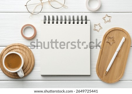 Flat lay composition with open blank notebook on white wooden table
