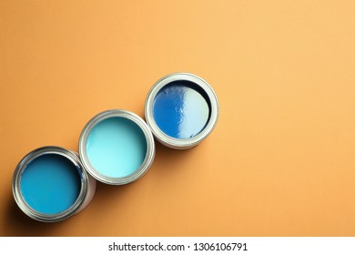 Flat lay composition with paint cans and space for text on color background