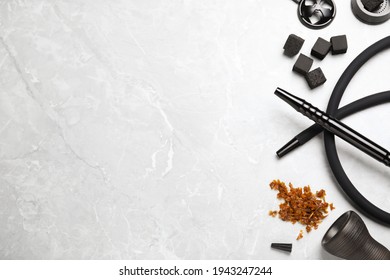 Flat lay composition with parts of hookah on marble table, space for text