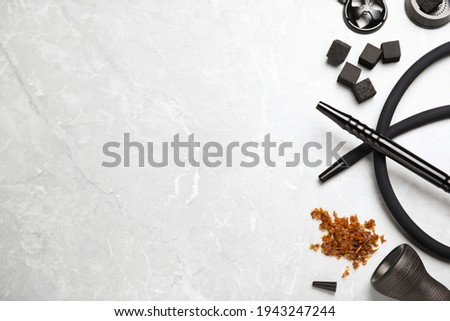 Flat lay composition with parts of hookah on marble table, space for text