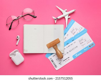 Flat Lay Composition With Passport, Stamp And Flight Tickets On Pink Background