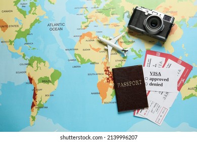 Flat lay composition with passport and tickets on world map. Space for text - Shutterstock ID 2139996207
