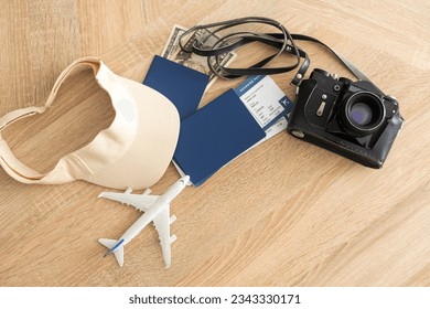 Flat lay composition with passport, toy plane and tickets on white wooden background, space for text. Visa receiving. - Shutterstock ID 2343330171