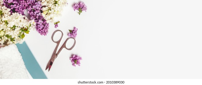 Flat lay composition with personal care products with branches of lilac on white table.background. Nails care. Manicure, pedicure beauty salon concept. Banner