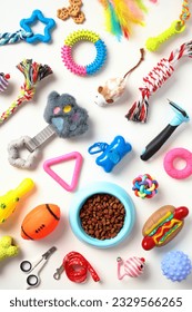 Flat lay composition with pet training supplies and bowl of dry food on white background. Pet care concept.