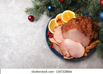 Flat Lay Composition With Plate Of Christmas Ham On Grey Table. Space For Text