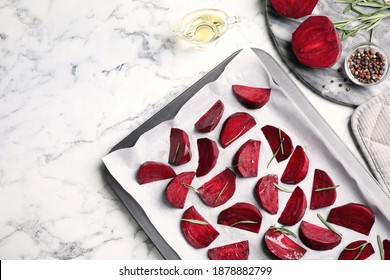 Flat lay composition with raw beetroot slices on white marble table
