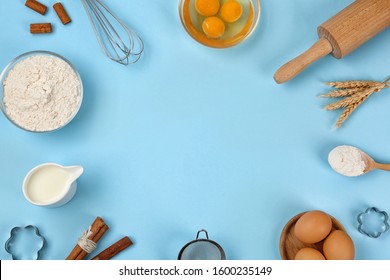 Flat lay composition with raw eggs and other ingredients on light blue background, space for text. Baking pie