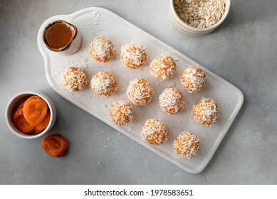 flat lay composition with raw vegan energy balls on ceramic board. healthy vegan food concept. Gray background