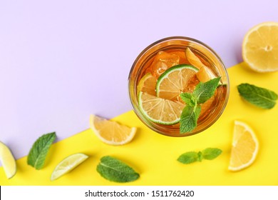 Flat lay composition with refreshing iced tea on color background