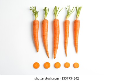 Flat lay composition with ripe fresh carrots on white background - Shutterstock ID 1337934242