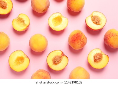 Flat lay composition with ripe peaches on color background