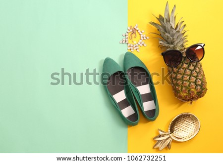 Flat lay composition with ripe pineapple, sunglasses and shoes on color background