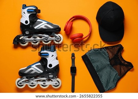 Flat lay composition with roller skates on orange background