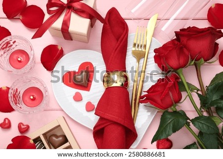 Flat lay composition with romantic place setting for Valentine's day on pink wooden table