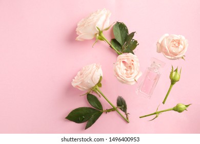 Flat lay composition with rose essential oil and flowers on pink background. Space for text - Shutterstock ID 1496400953