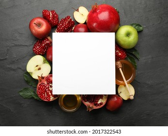 Flat lay composition with Rosh Hashanah holiday attributes and card on black background. Space for text