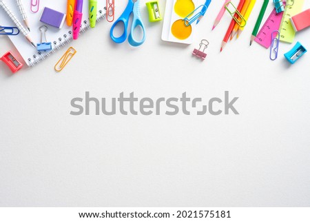 Flat lay composition with school supplies on white background. Frame of colorful stationery. Back top school concept. Top view, overhead.